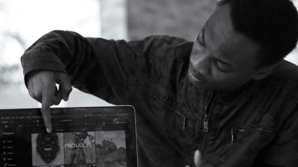Man in Nigeria pointing at a laptop screen