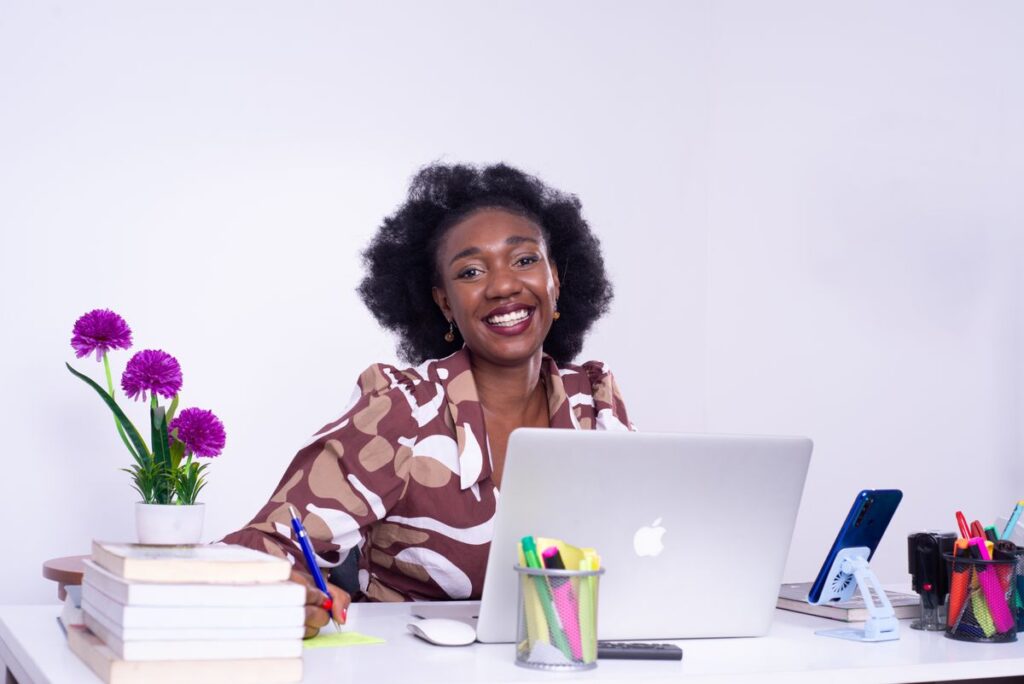 African businesswoman smiling at her desk in an office